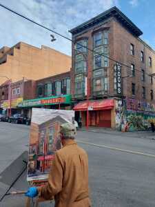 Reza Doust putting finishing touches on his painting of the Keefer Rooms/Gain Wah building on Friday, September 12, 2025. Photo Credit: Russell Chiong. Photo Source: Chinatown Today.