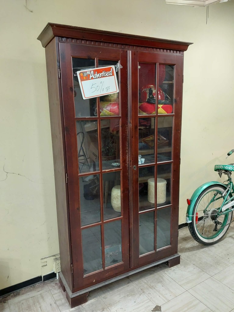 Brown rosewood display case with glass panels. 
